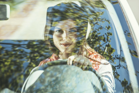 Spain, Barcelona, Young woman in car stock photo