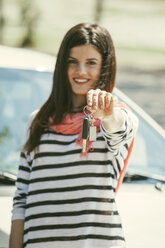 Spain, Barcelona, Smiling young woman holding car keys - EBSF000231