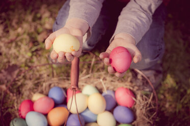 Boy in garden holding Easter eggs - MJF000982