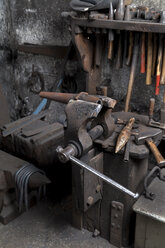 Germany, Bavaria, Josefsthal, bench vice, hammer and anvil beaks at historic blacksmith's shop - TCF003947