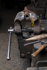 Germany, Bavaria, Josefsthal, bench vice, hammer and anvil beak at historic blacksmith's shop - TCF003948