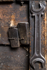 Germany, Bavaria, Josefsthal,two bolts and screw wrench at historic blacksmith's shop - TCF003949