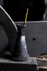 Germany, Bavaria, Josefsthal, oil squirt with lubricante and brush at historic blacksmith's shop - TCF003988