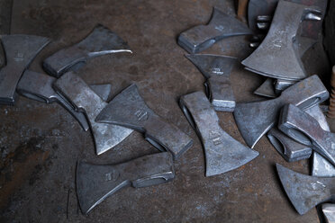 Germany, Bavaria, Josefsthal, work pieces of axes at historic blacksmith's shop - TCF003955