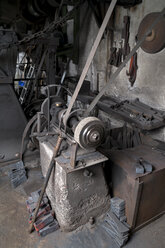 Germany, Bavaria, Josefsthal, grinder at historic blacksmith's shop - TCF003956