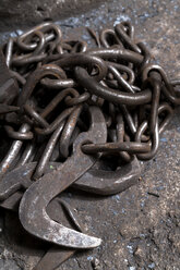Germany, Bavaria, Josefsthal, old chain and hooks at historic blacksmith's shop - TCF003972