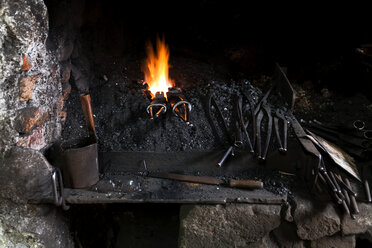 Germany, Bavaria, Josefsthal, forge with fire at historic blacksmith's shop - TCF003977