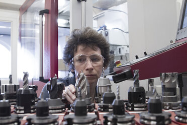 Germany, Freiburg, Female technician working in a metalworking workshop - SGF000610