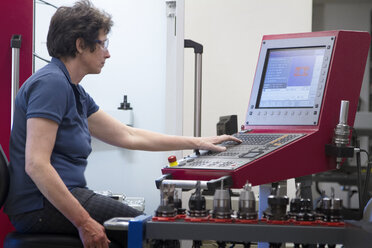 Germany, Freiburg, Female technician working in a metalworking workshop - SGF000600