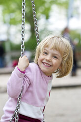 Portrait of smiling little girl on swing - JFEF000343