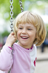 Portrait of smiling little girl on swing - JFEF000344