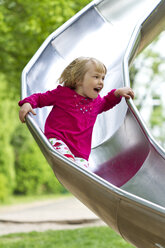 Little girl sliding on chute - JFEF000352