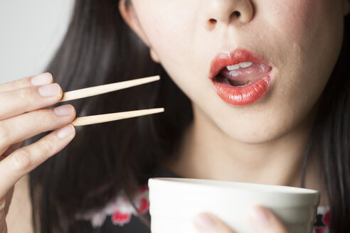 Asian woman eating with chopsticks - FLF000508