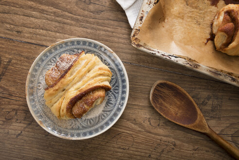 Teller mit Franzbrötchen auf Holztisch, Ansicht von oben - CSTF000325