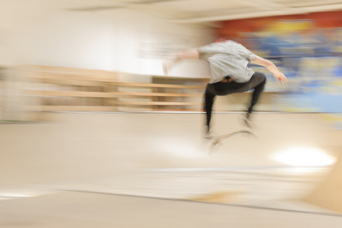 Skate boarder making Kickflip at skateboard ground stock photo