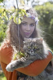 Portrait of female teenager with cat on her arms - SARF000569