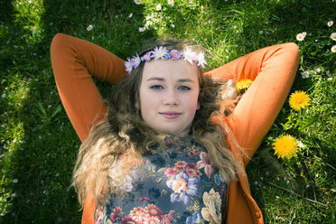 Portrait of female teenager lying on meadow, view from above - SARF000563