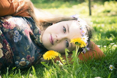 Portrait of female teenager lying on meadow - SARF000564