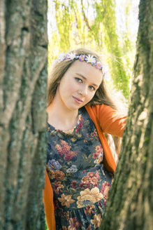 Portrait of female teenager wearing flowers - SARF000567
