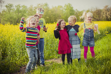 Six children standing in front of rape field - MJF001111