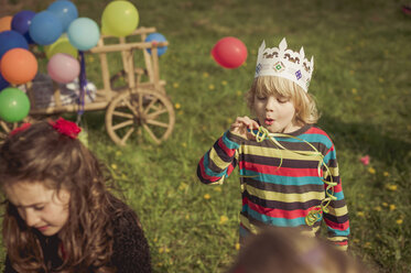 Little boy blowing streamer - MJF001160