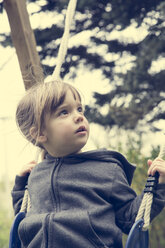 Portrait of little girl sitting on a swing - LVF001155