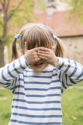 Little girl covering her eyes with hands - LVF001184