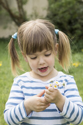 Portrait of little girl holding daisies in her hands - LVF001190