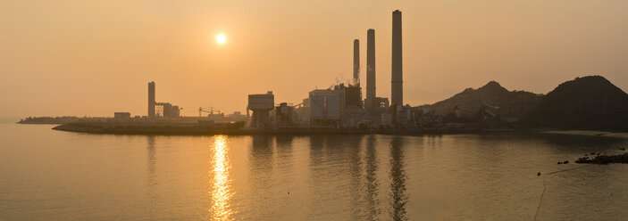 China, Hong Kong, Lamma Island, sunset over a coal-fired power plant in Yung Shue Wan bay - SHF001244