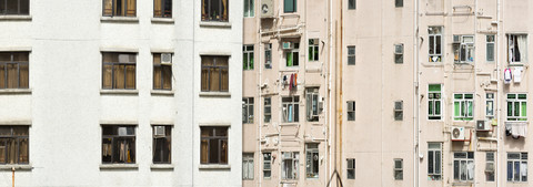 China, Hongkong, Mid Levels, trostlose Fassade eines Hochhauses mit Fenstern, Waschküche, Fallrohren und Klimaanlagen, lizenzfreies Stockfoto