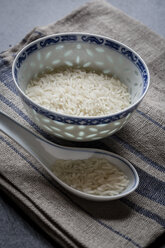 Bowl and porcelain spoon of jasmine rice on cloth and slate - SARF000590