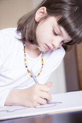 Portrait of little girl painting with wax crayon - LVF001229