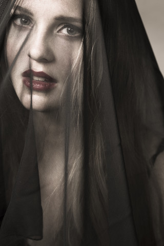 Portrait of young woman wearing mourning veil stock photo