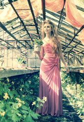 Young woman wearing evening dress standing in old greenhouse - FCF000202