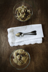 Two glass bowls of sugar-free rhubarb compote with raisins, cloth and tea spoons, elevated view - EVGF000572