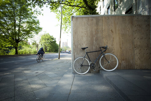Racing cycle parked at wooden fence - MKL000001