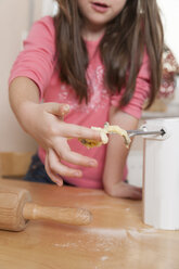 Little girl nibbling dough, partial view - ECF000625