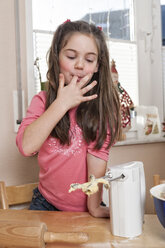 Portrait of little girl stirring dough - ECF000626