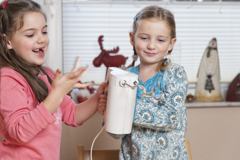 Portrait of two little girls with mixer stock photo