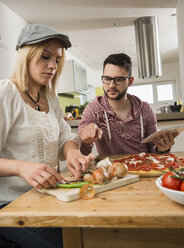 Couple cooking in kitchen at home - UUF000548
