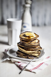 Stack of American pancakes with melting butter and maple syrup - SBDF000921