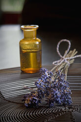 Lavender oil in a glass bottle, twigs of lavender, Lavandula angustifolia - ASF005362