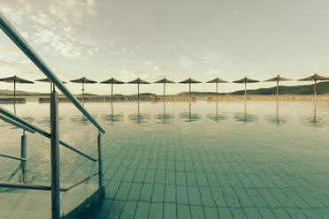 Croatia, Sibenik, Sunshades, Swimming pool of a hotel facility, Evening mood - MEMF000164