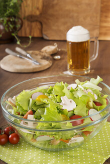 Mixed salad in glass bowl and glass of beer - CSTF000362