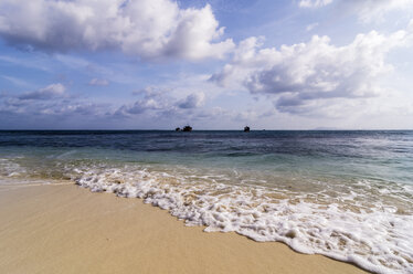 Indonesia, Riau Islands, Bintan, Nikoi Island, Beach with fishing boats in background - THAF000358