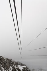 Austria, Tyrol, Innsbruck, Steel cables of Hungerburg railway disappearing in high fog - GFF000490
