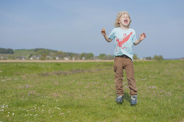 Germany, Mecklenburg-Western Pomerania, Ruegen, Screaming boy on meadow - MJF001209