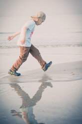Germany, Mecklenburg-Western Pomerania, Ruegen, Boy walking at the ocean - MJF001187