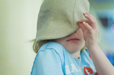 Blond hiding his face with a cap - MJF001193