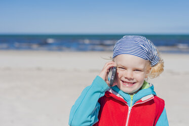 Deutschland, Mecklenburg-Vorpommern, Rügen, Schaabe, Junge am Handy am Strand - MJF001220